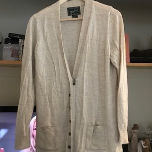 Heathered cream colored wool sweater with a zipper